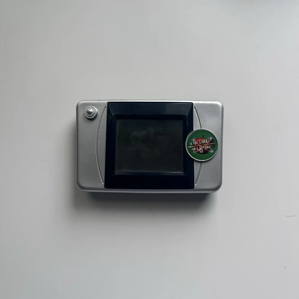 2007 Are You Smarter Than a 5th Grader Illuminated Electronic Handheld LCD Game